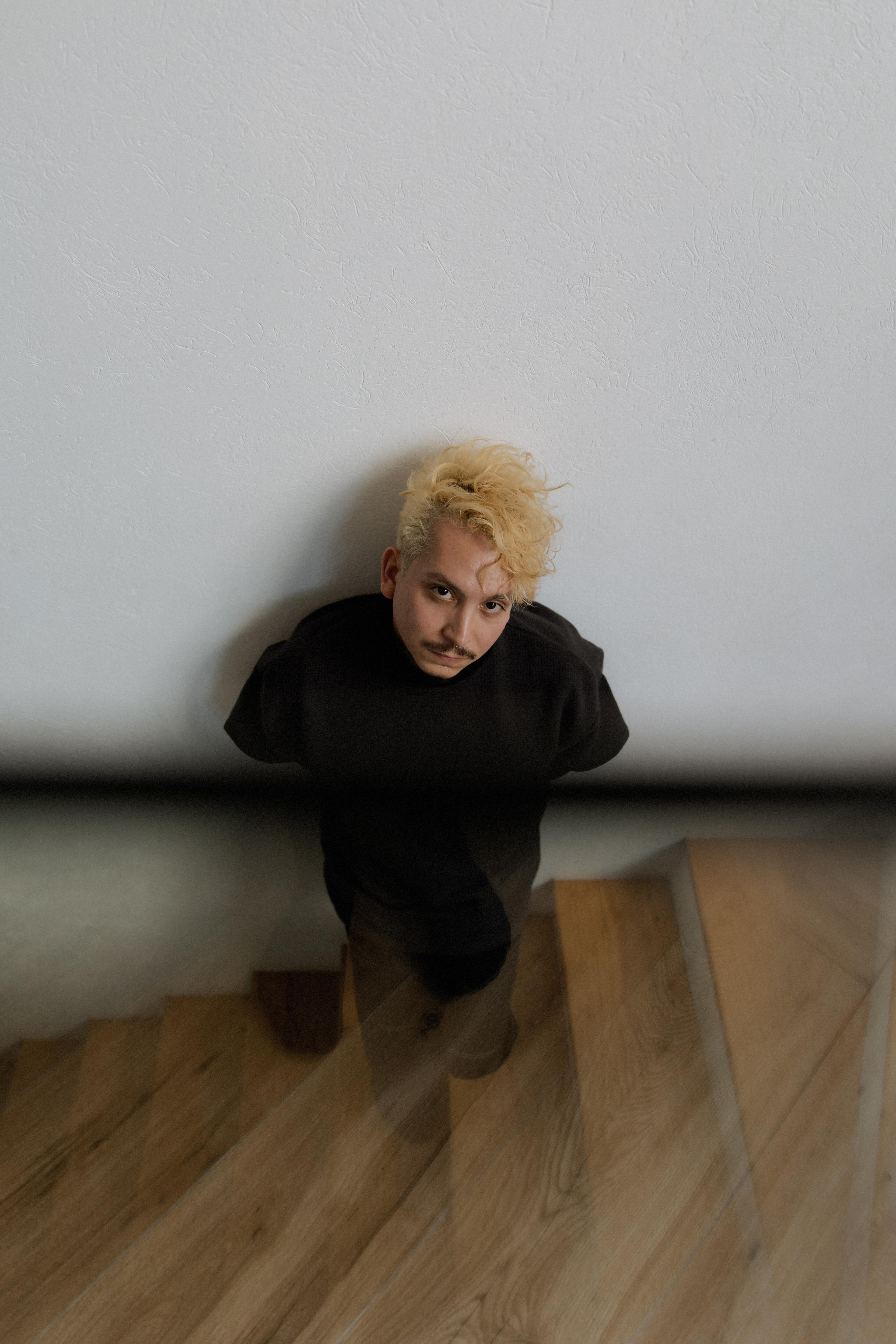 A portrait of Milton Guillén on a stairwell.