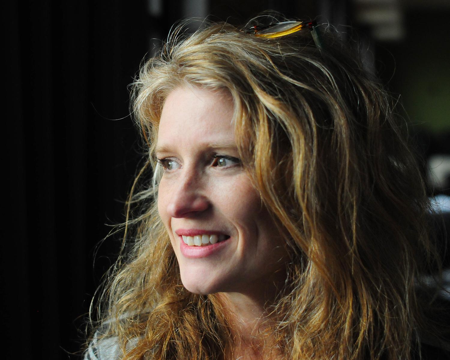 Cynthia Hill smiles and looks away from the camera.