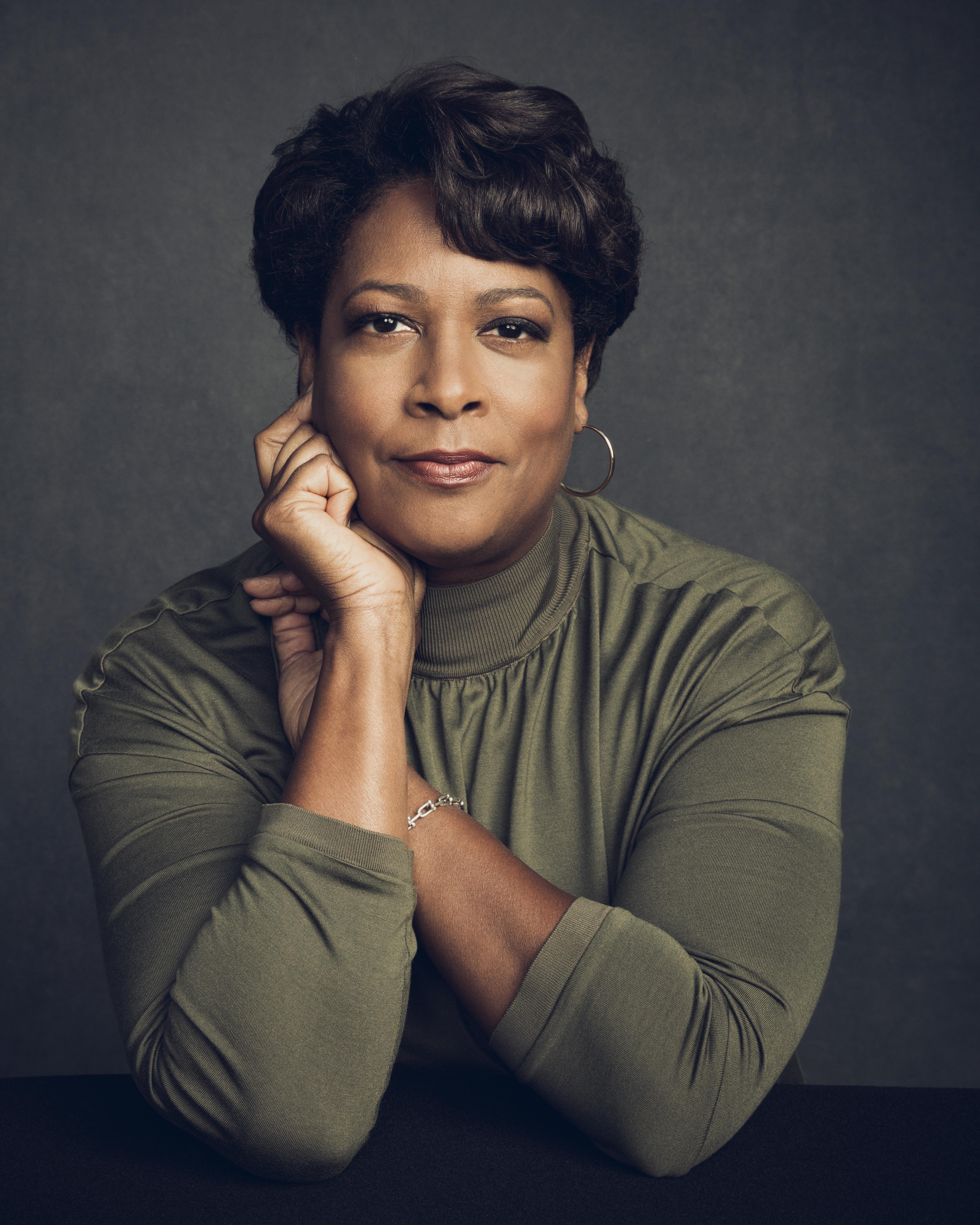 A portrait of Dawn Porter against a grey backdrop.