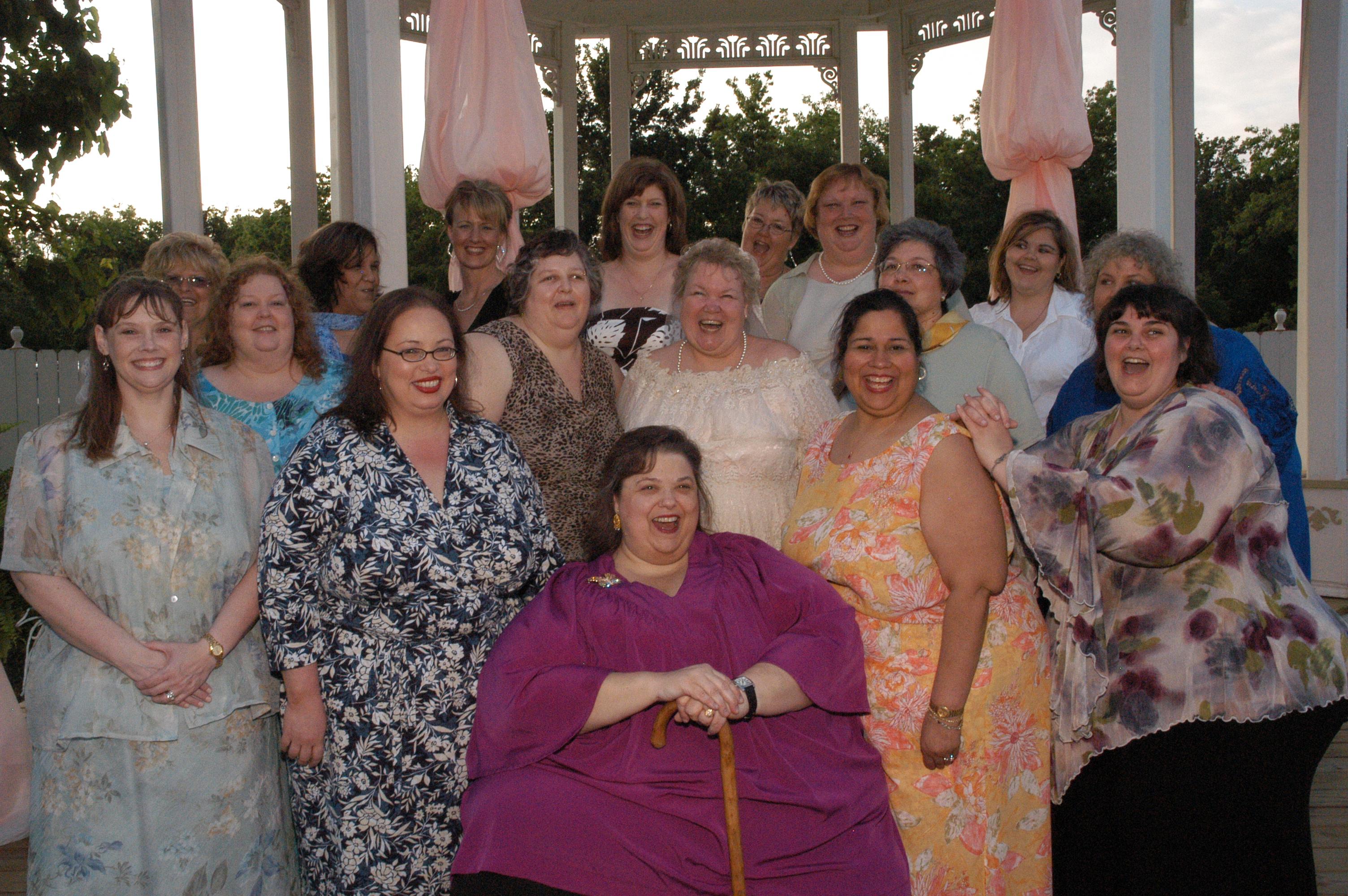 A group of women gathered together and smiling at the camera.