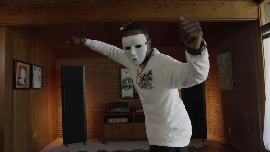 Still from The People Could Fly. A man wearing a mask comes towards the camera.