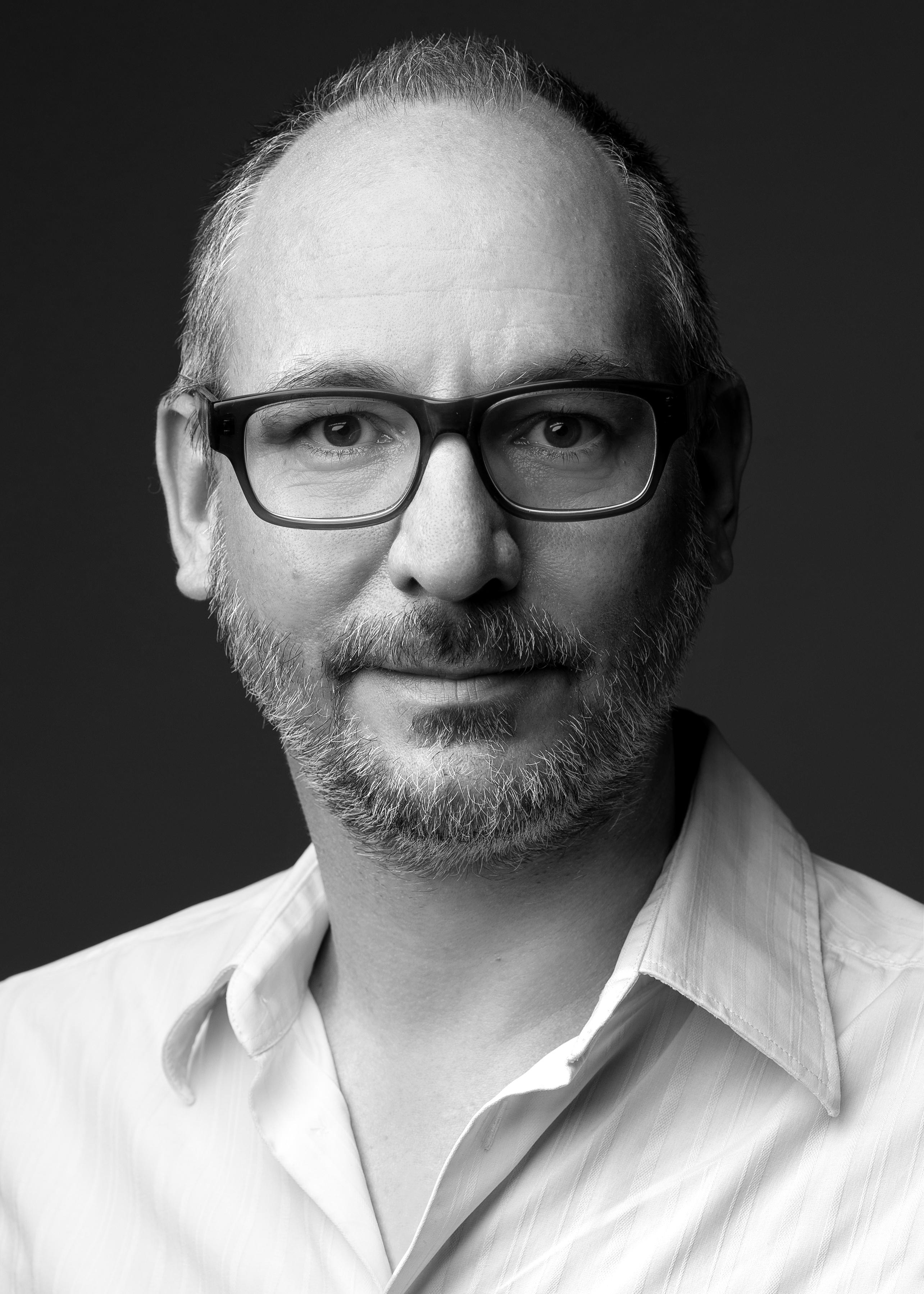 Headshot of Erik Winker in black and white