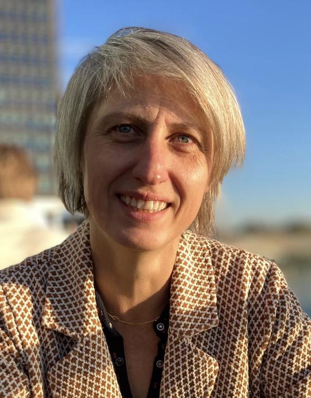 Carine Chickowsky looks directly at the camera and smiles.